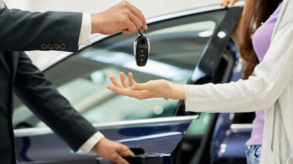 man giving keys to a woman